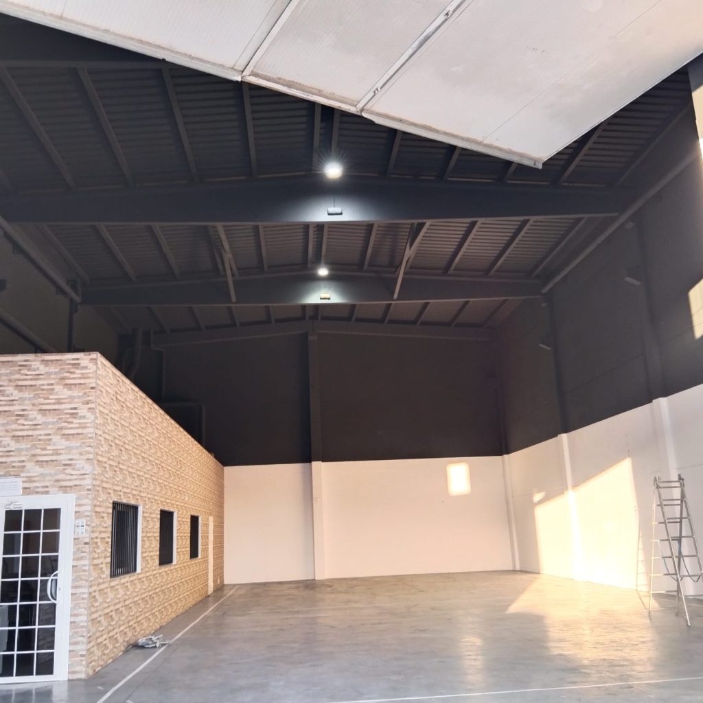 Interior de espacio industrial pintado profesionalmente en Valencia, mostrando acabado resistente y duradero